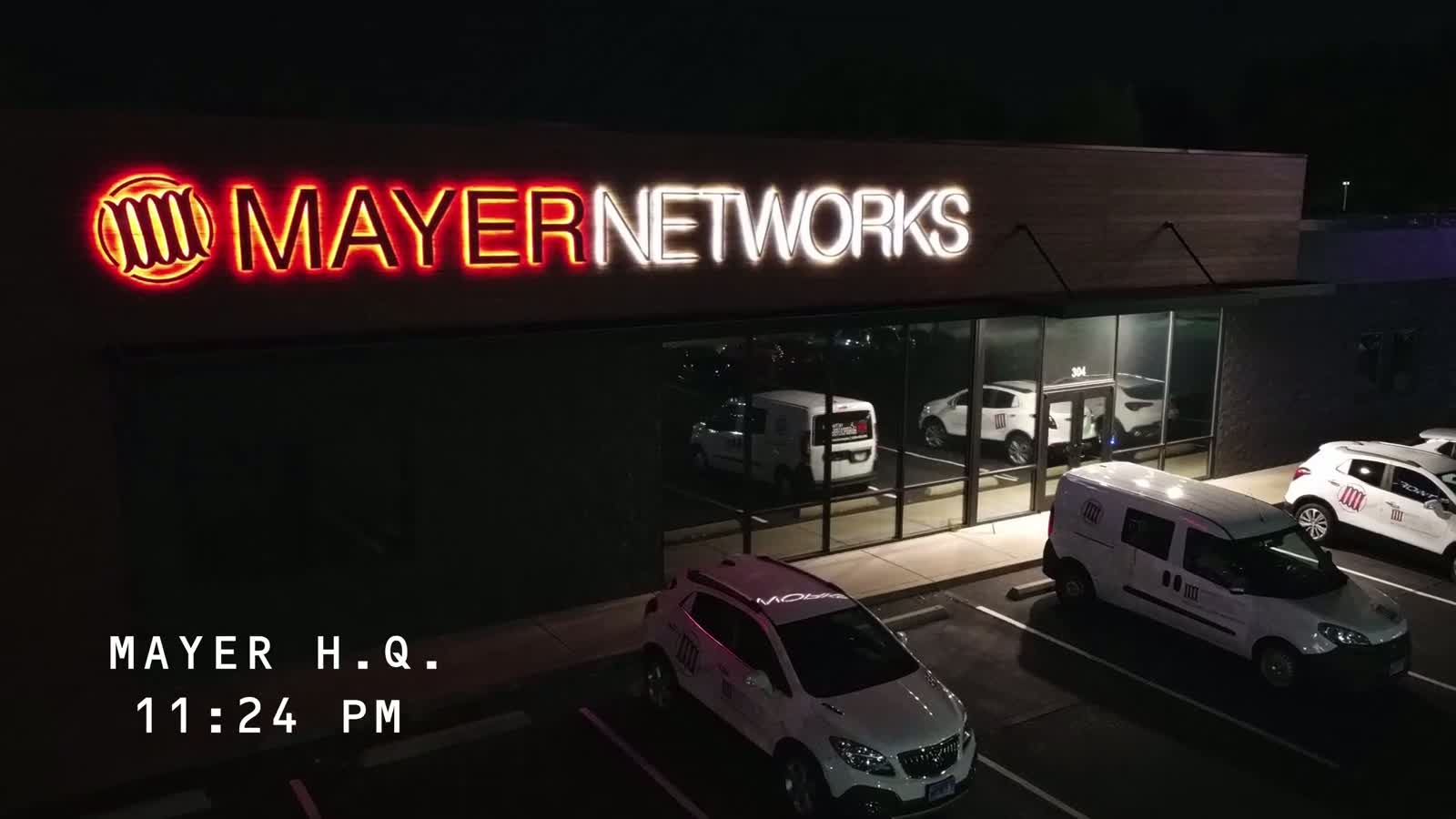 The Mayer Networks office and service vehicles in Carbondale, Illinois at night